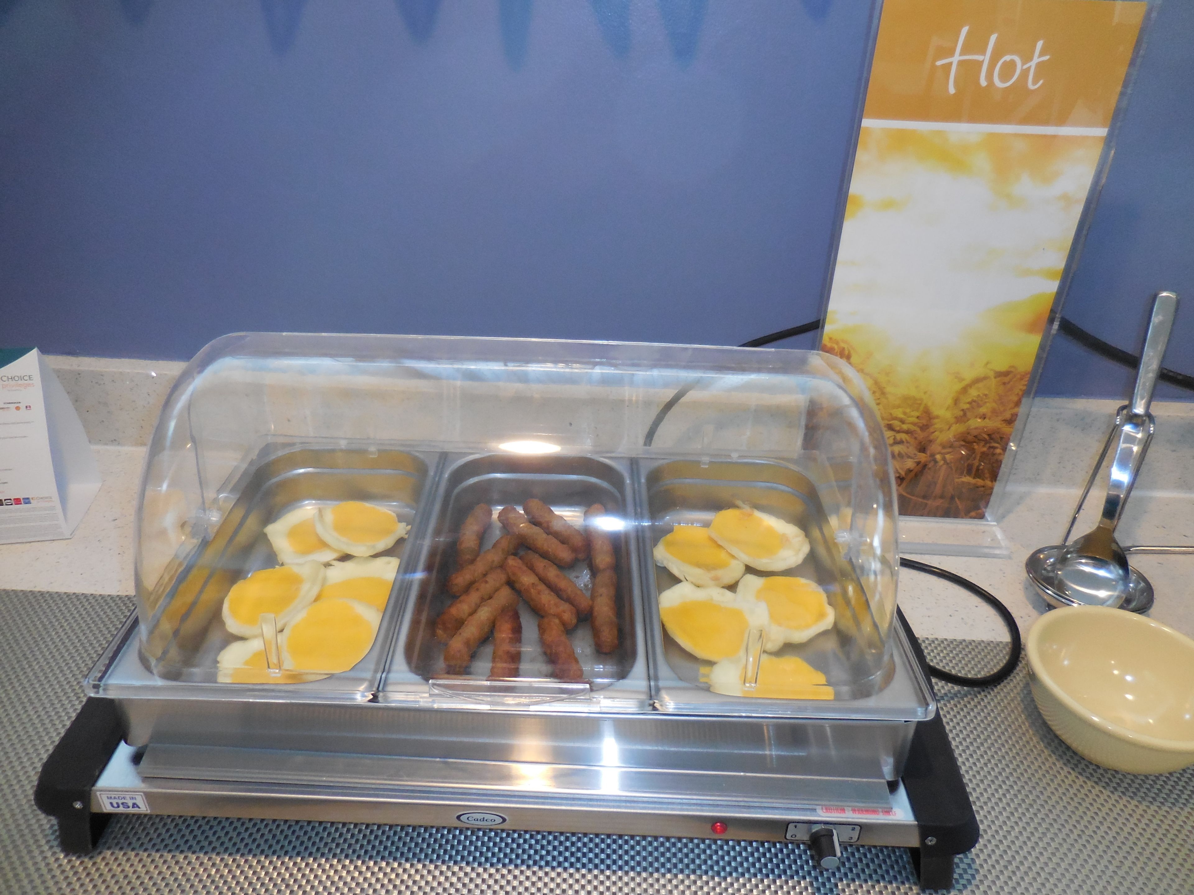 A buffet with various food items including eggs and sausages.