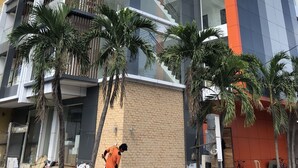 A multi-story building with a modern architectural design, featuring a mix of glass and brick facades, and a visible staircase on the right side. - Apollonia Royale Hotel (Angeles City)