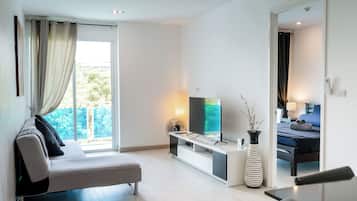 Apartment | Living area | 42-inch flat-screen TV with cable channels, TV, DVD player