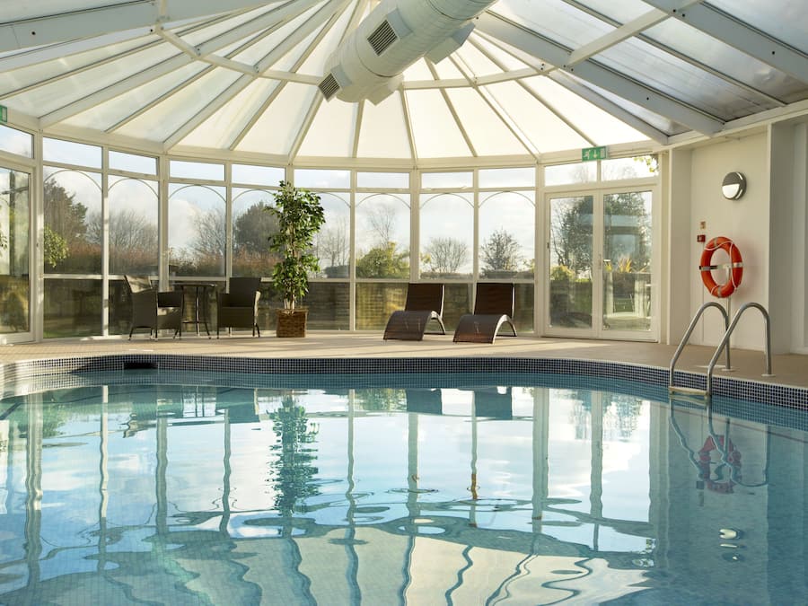 Indoor pool, open 7:00 AM to 9:00 PM, pool loungers