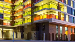 A multi-story hotel with balconies, large windows, and a modern architectural design. - Rocco Hua Hin Beach Seaview (Hua Hin)