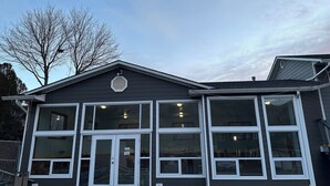 A two-story building with large windows and a garage door. - Kings Motor Inn (Kamloops)