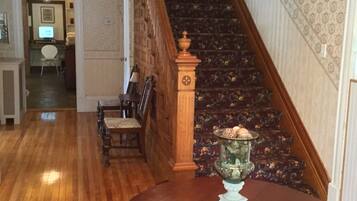 A staircase with wooden railings and a patterned carpet.