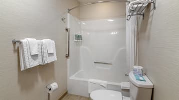 A bathroom with a shower, toilet, and towel rack.
