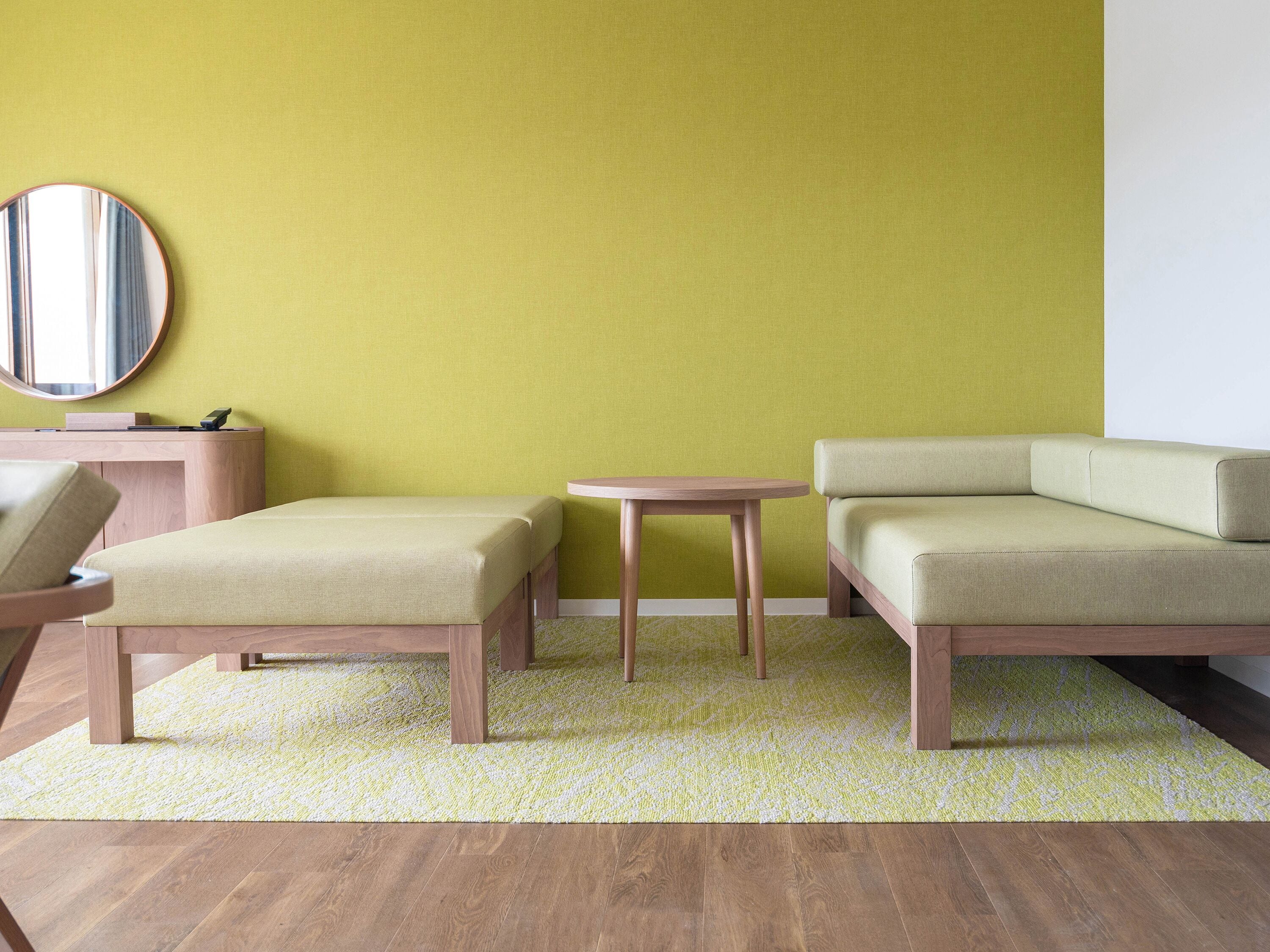 A modern living room with a sofa, a small table, and a chair.