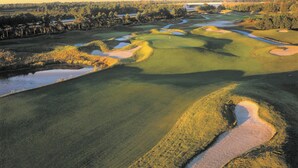A golf course with water hazards, sand bunkers, and a flagstick. - Club Wyndham Dye Villas (North Myrtle Beach)
