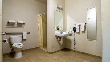 A bathroom with a toilet, a sink, a shower curtain, a towel rack, and a mirror.
