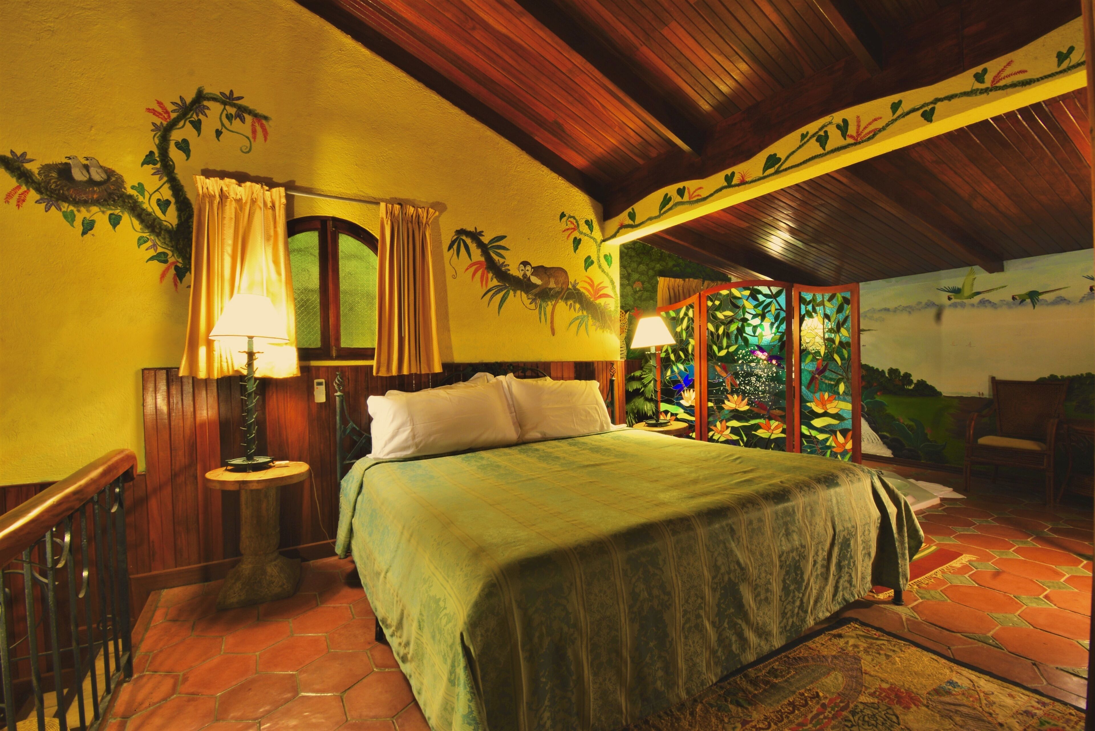 A room with a bed, a nightstand, a lamp, and a chair.