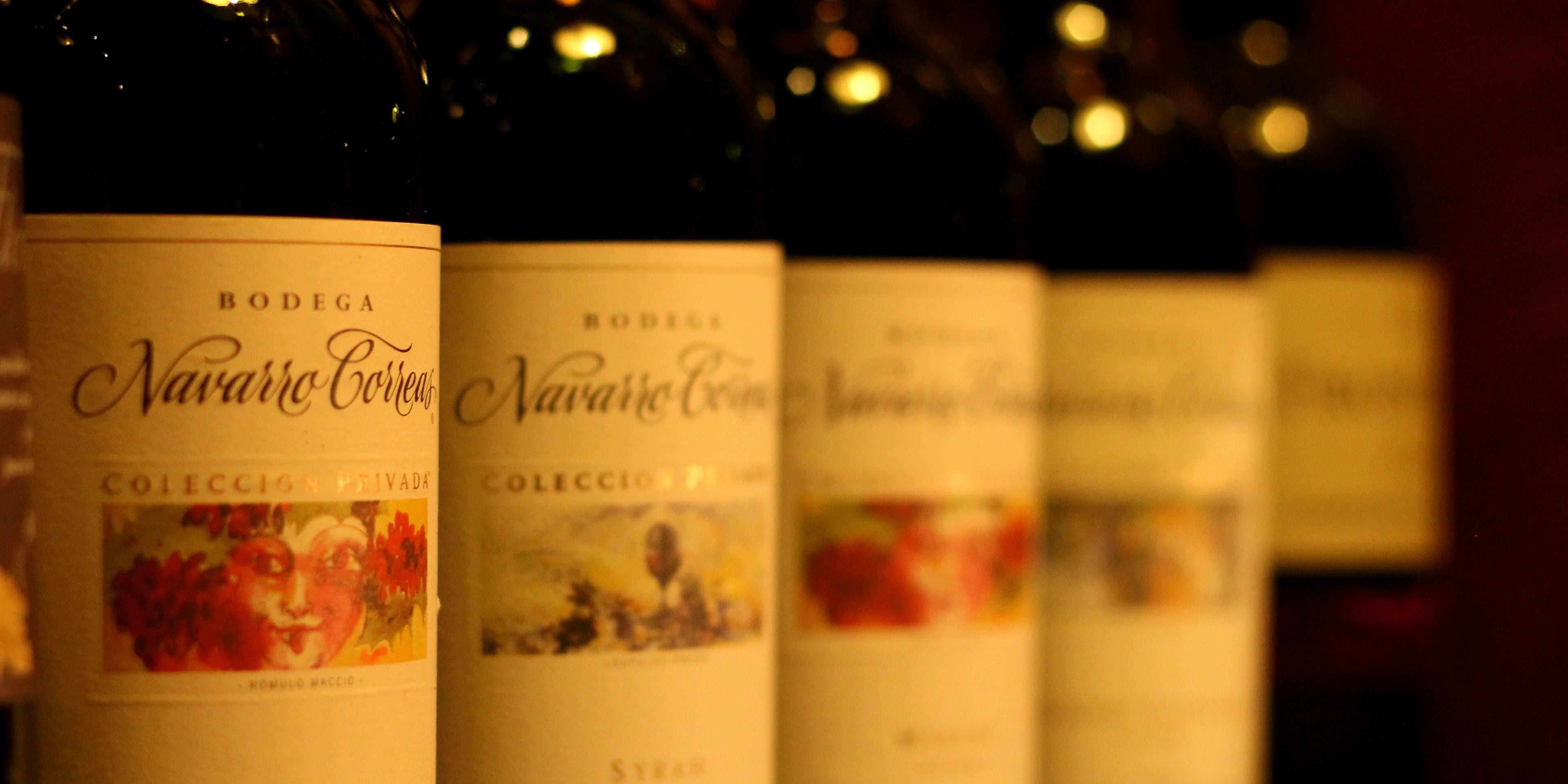 A row of wine bottles with labels.