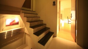 A staircase with a plaque and a framed picture. - Silom One (Bangkok)
