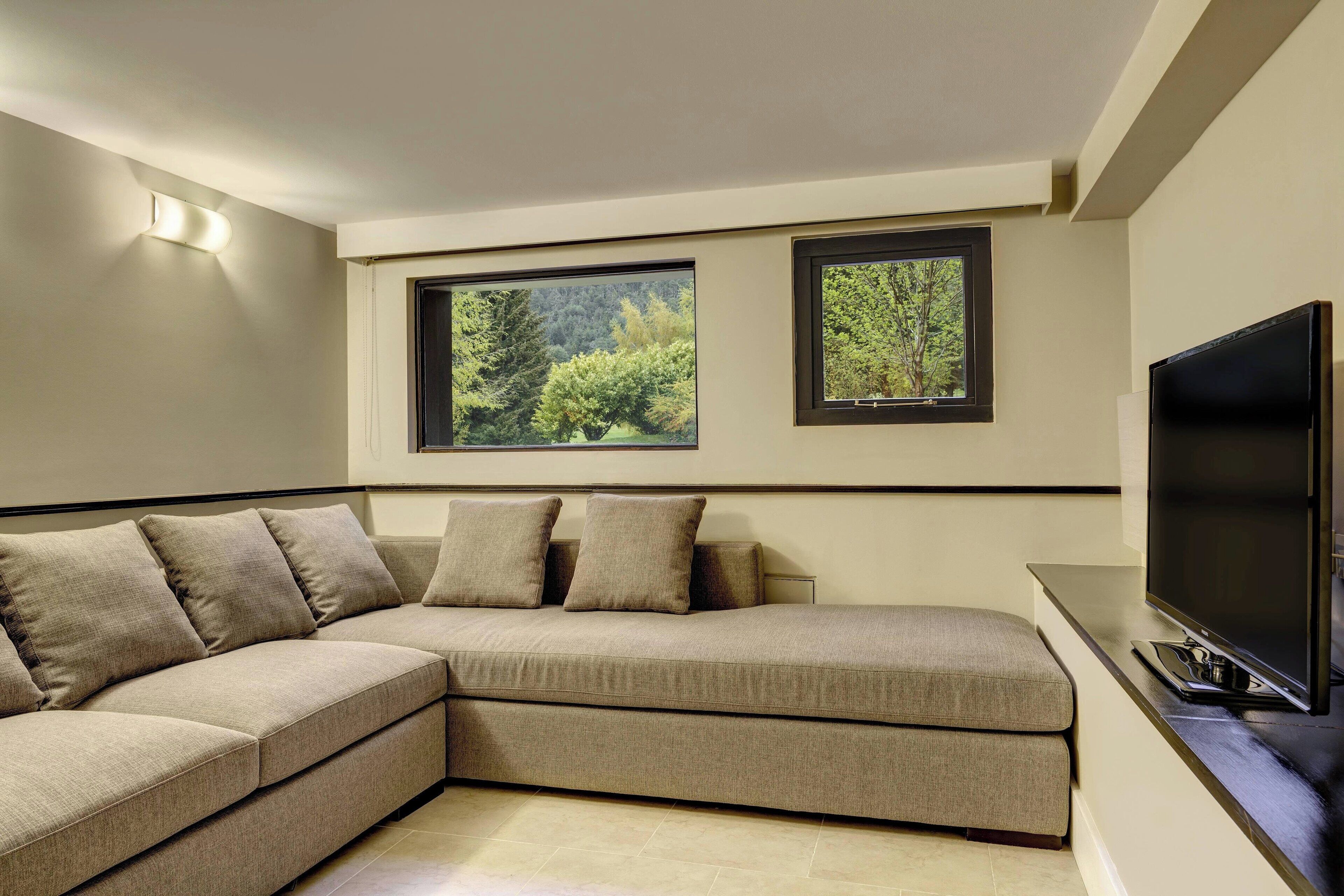 junior suite, 1 king bed with sofa bed | living room | 32-inch lcd tv with satellite channels, tv, pay films