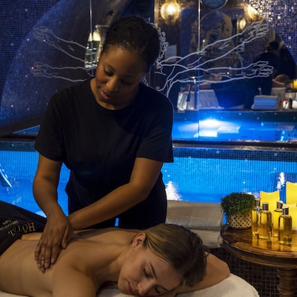 A person receiving a massage by a poolside.