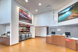 Welcome to our reception area, featuring a spacious open layout, a snack bar, and a large digital clock.