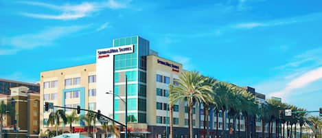 A hotel with a prominent sign for 'Spiegel Suites' and 'Spiegel Suites' on the building facade.