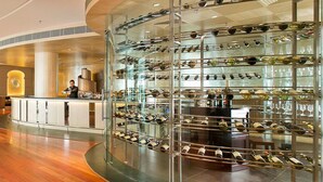 A modern hotel lobby with a bar area featuring a wine and glass display. - The Lalit Traveller Jaipur (Jaipur)