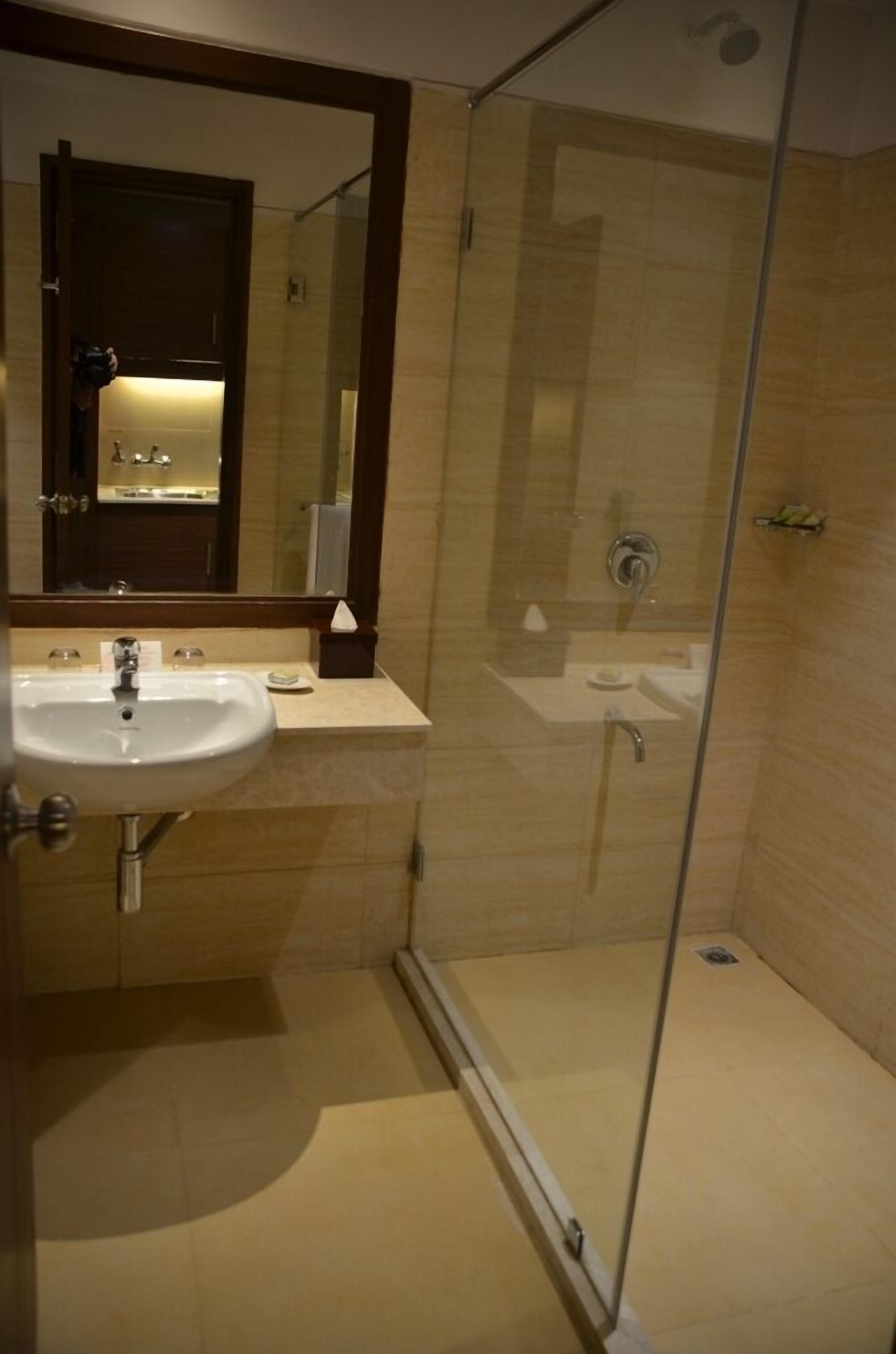 shower, hair dryer, slippers, towels