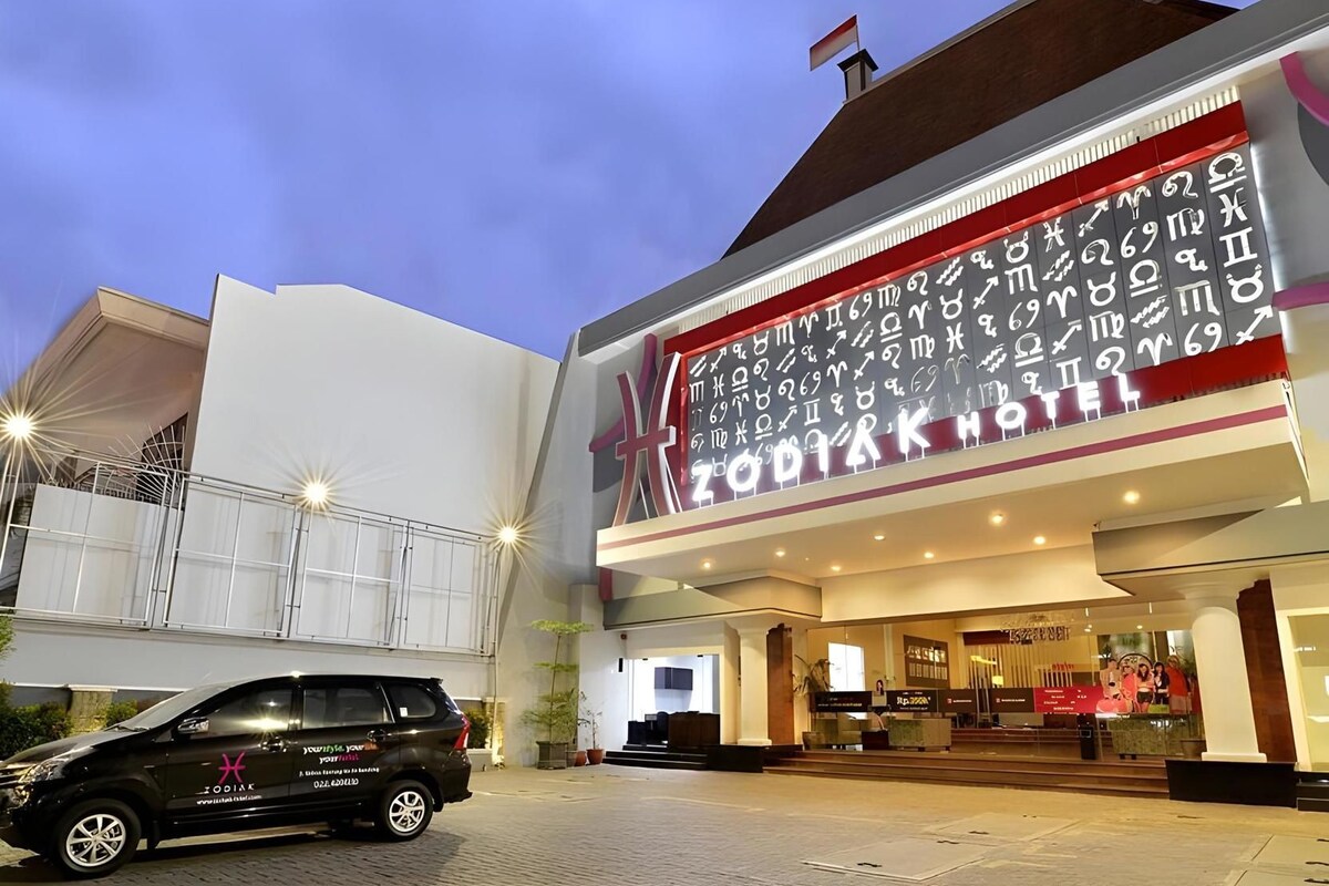 A hotel with a prominent zodiac sign display on the facade.