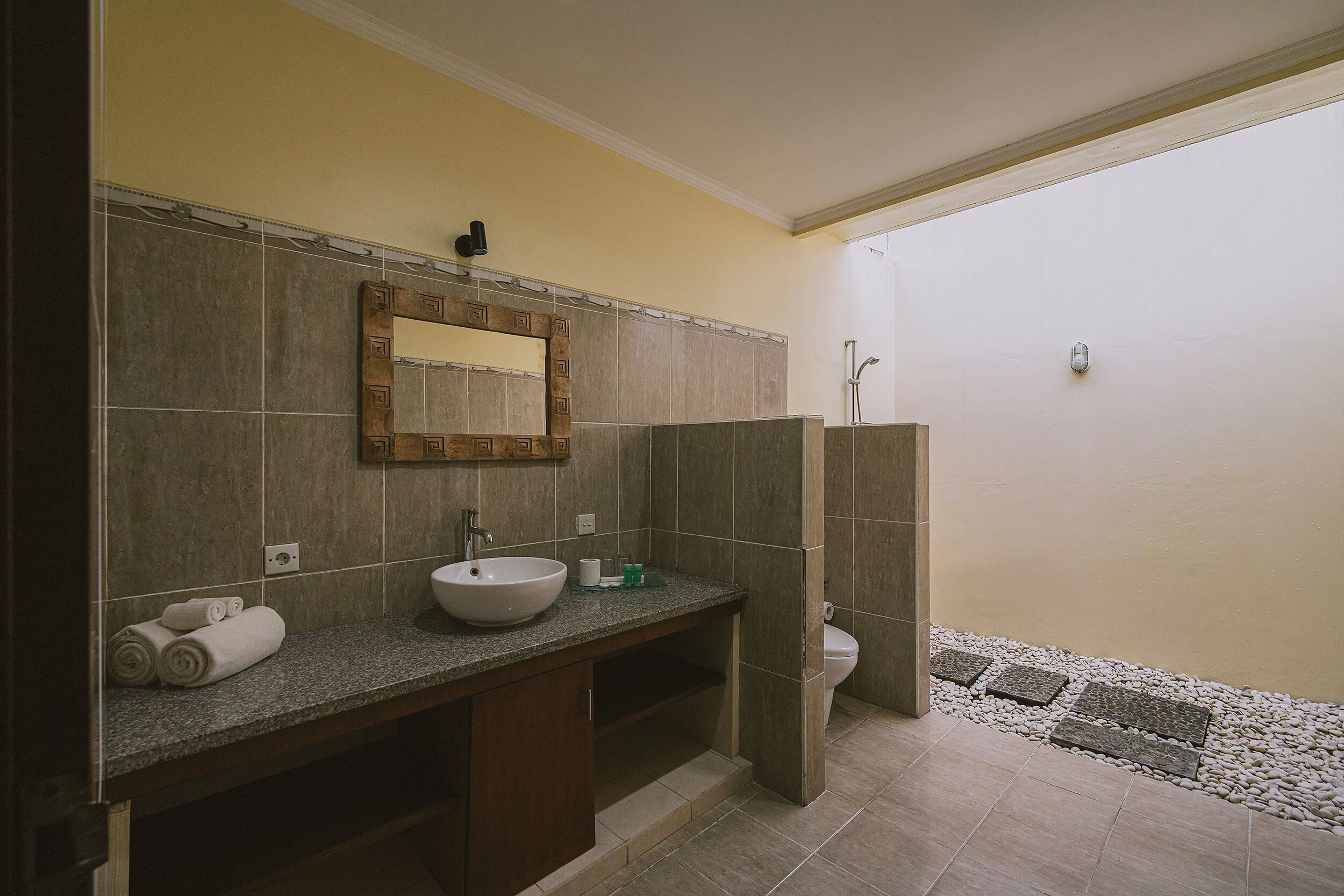 A bathroom with a large sink, mirror, and shower.