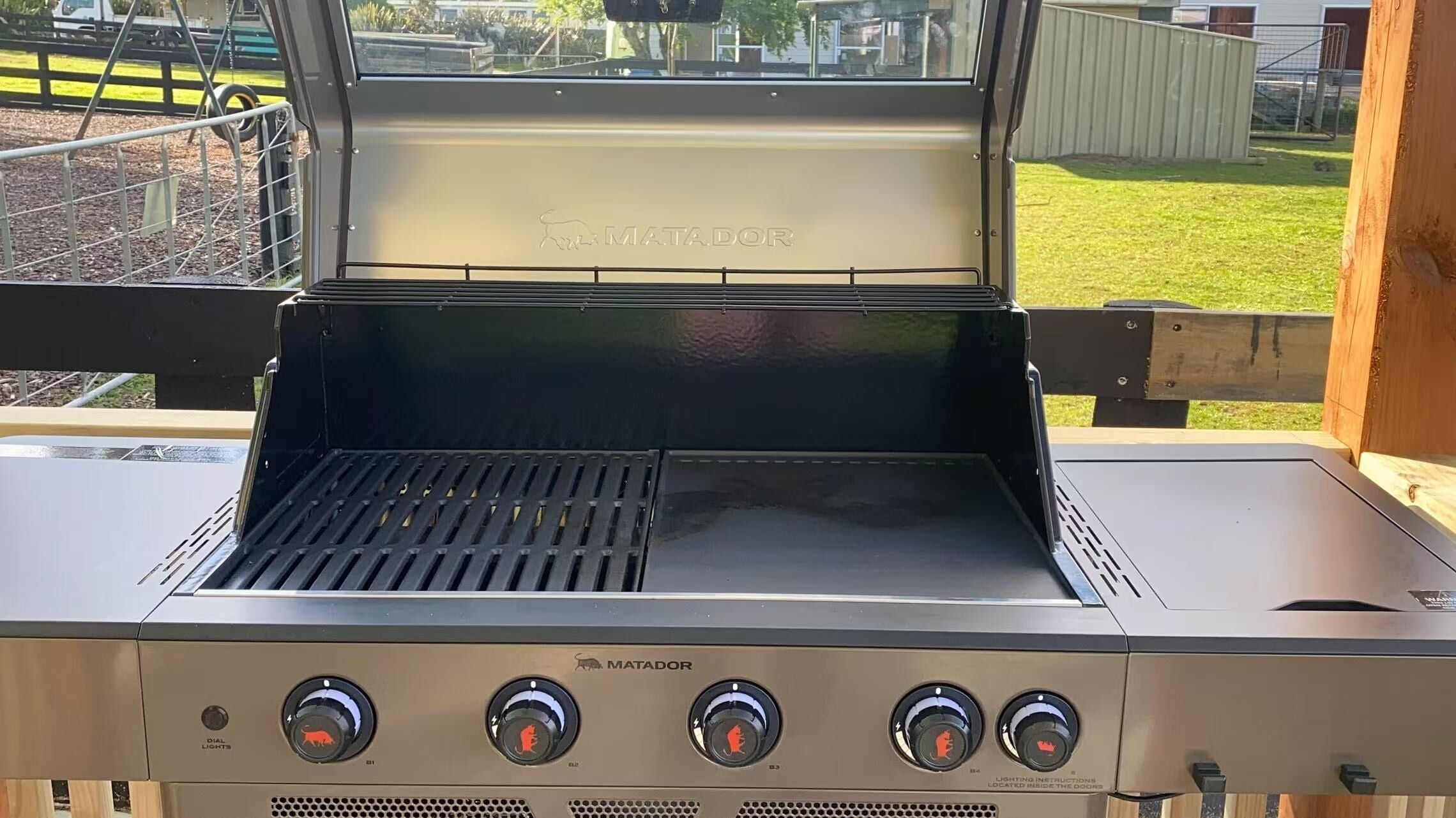 A MATADOR grill with four control knobs, a digital display, and a vented lid.