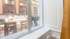 A window view of a shop with a sign reading "DALA SHOP" and another sign for "KERSTIN AC."