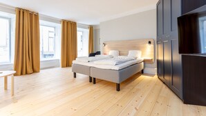 A modern bedroom with a bed, bedside tables, and a wardrobe.