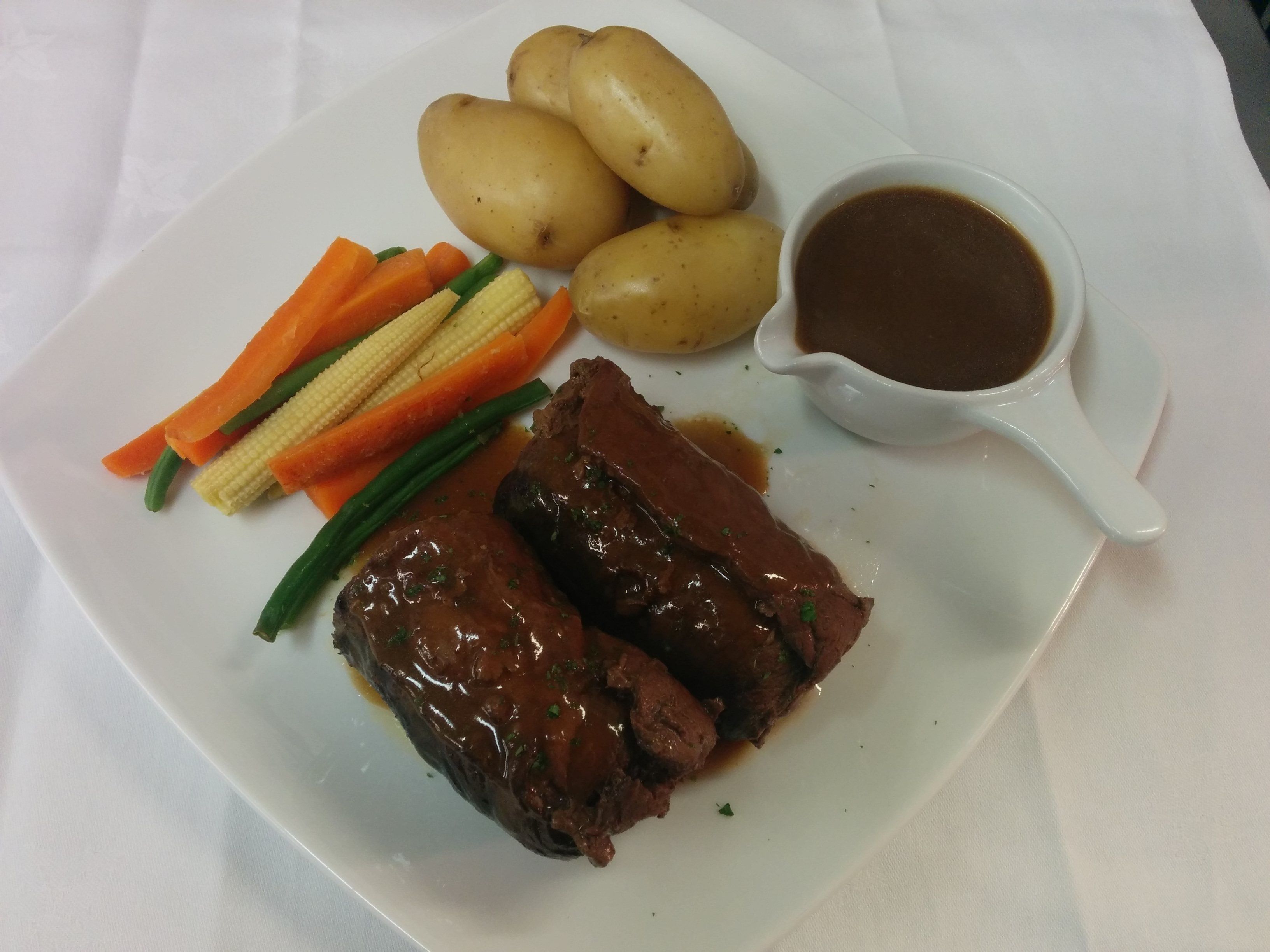 A plate with meat, potatoes, and vegetables.