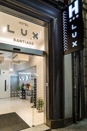 The entrance of Hotel LUX Santiago with a prominent illuminated sign and a clean, modern facade. - Lux Santiago Hotel (Santiago de Compostela)