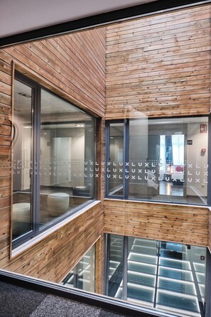 A modern interior with wooden paneling and large windows. - Lux Santiago Hotel (Santiago de Compostela)