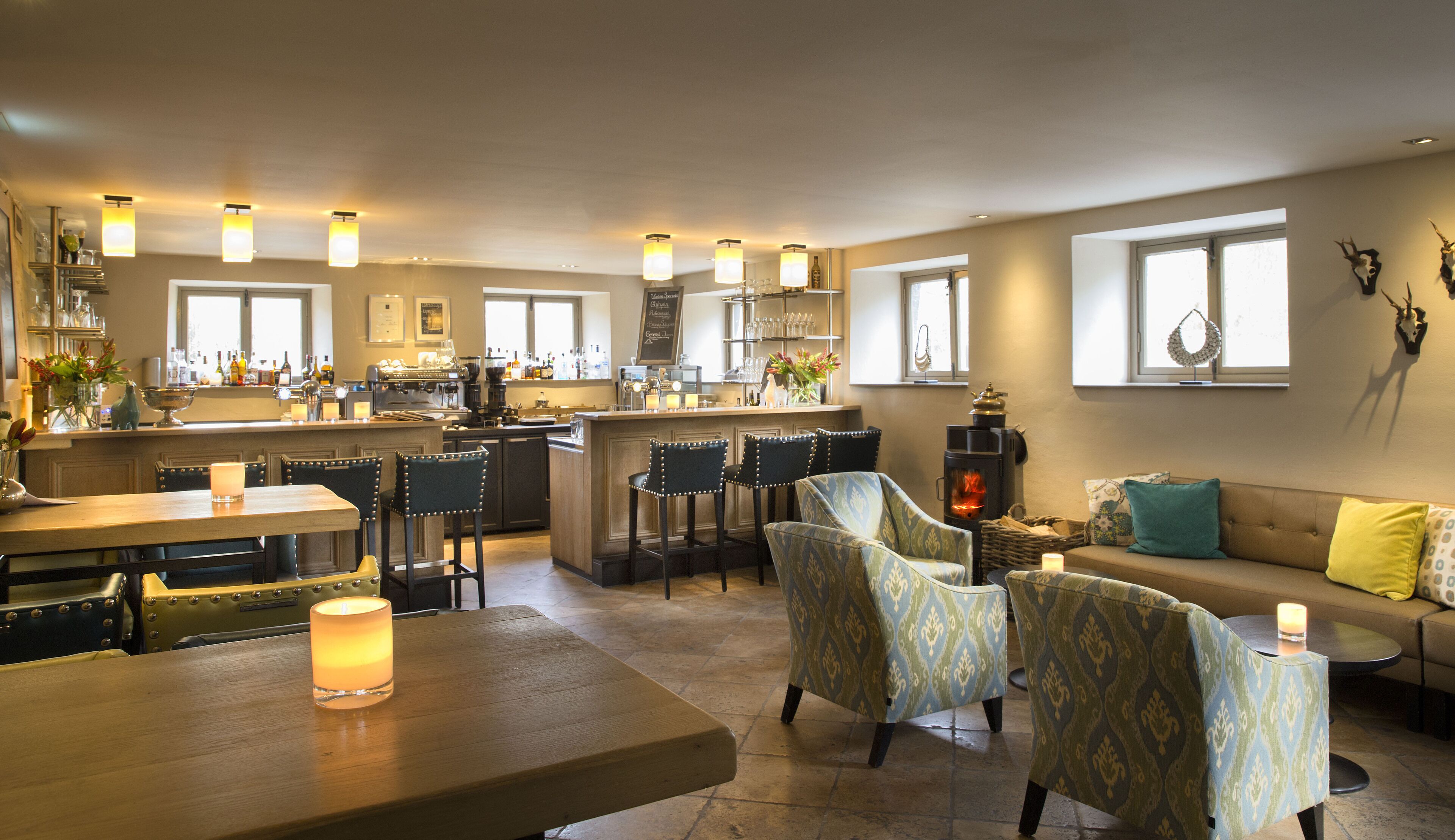 A spacious living area with a kitchen, bar, and seating area.
