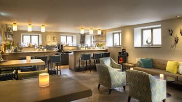 A spacious living area with a kitchen, bar, and seating area.