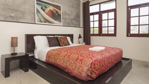 A hotel room with a large bed, a nightstand, a wall-mounted painting, and a window with curtains. - Kama Bangkok - Boutique Bed & Breakfast - Hostel (Bangkok)