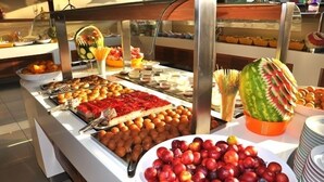 A buffet with various food items including fruits, pastries, and a watermelon centerpiece. - Telmessos Neva Hotel - Halal-Non Alcoholic  Hotel (Fethiye)