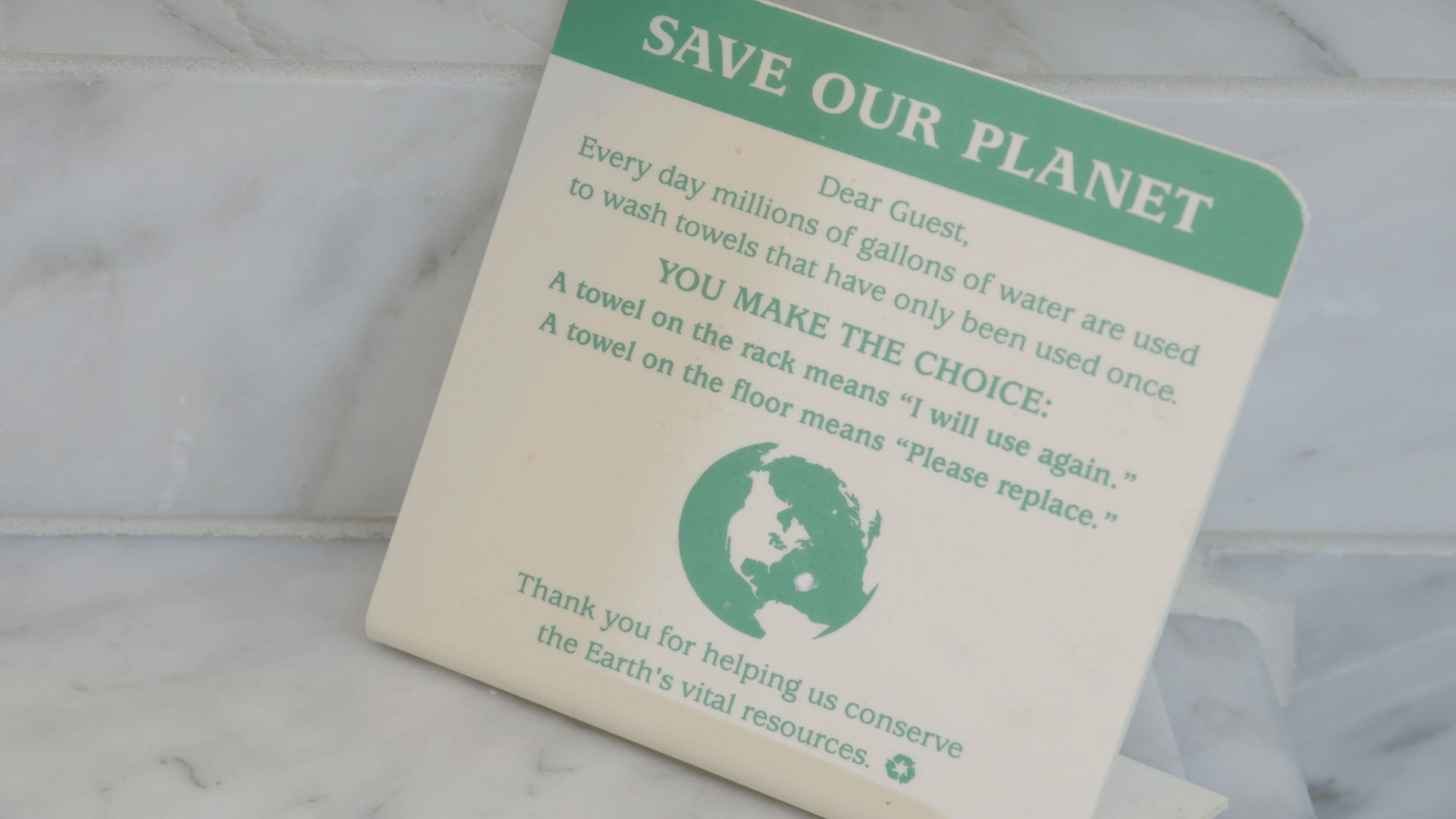 A sign with a message about conserving water.