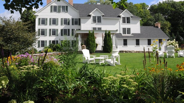 A large white house with a well-maintained lawn and outdoor seating area. - The Lyme Inn (Lyme)