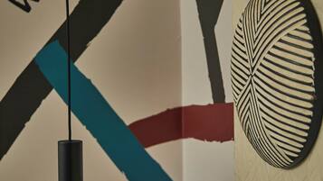 A wall with a 'WELCOME' sign and a decorative wall piece.