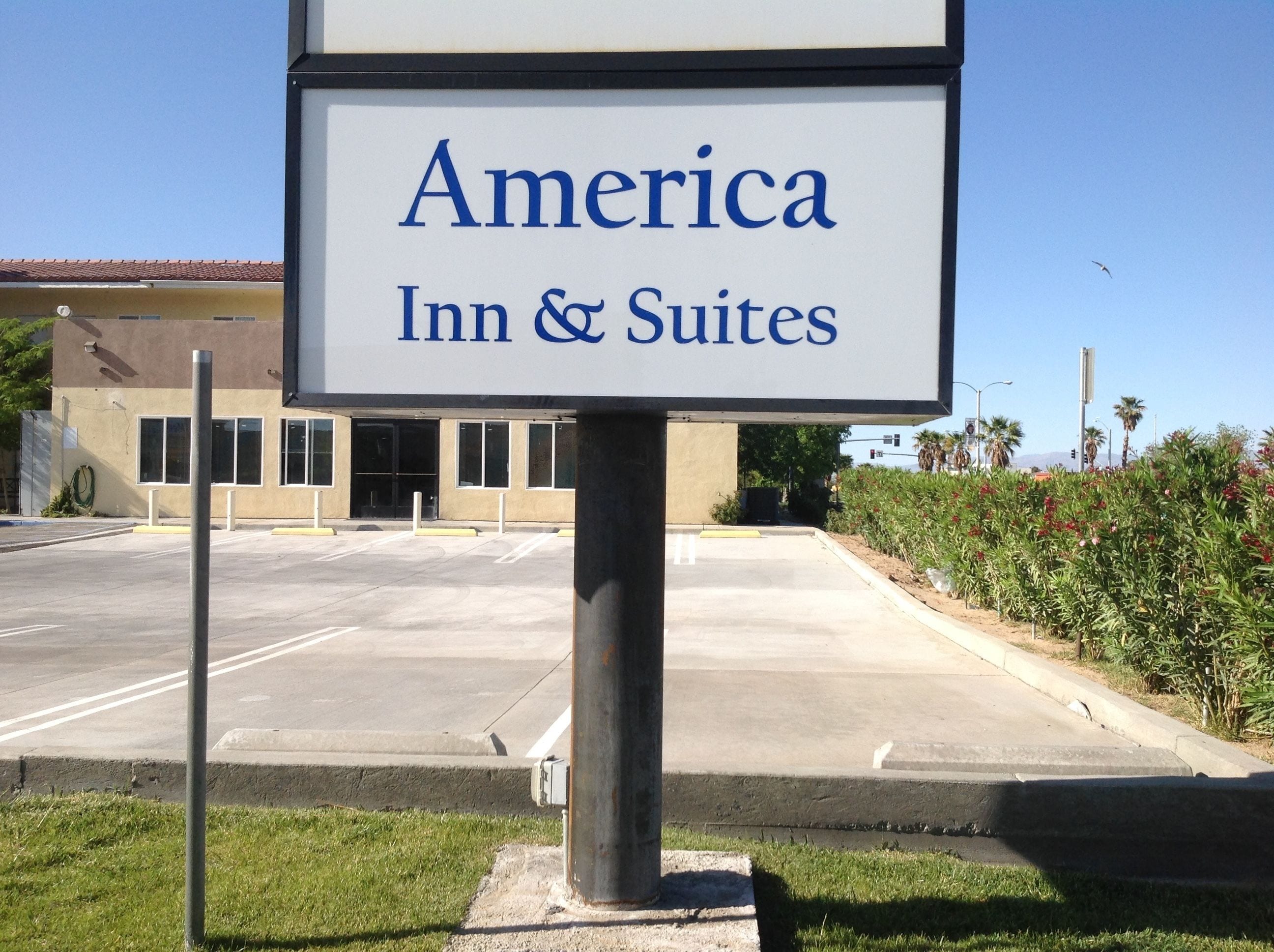A sign for America Inn & Suites.