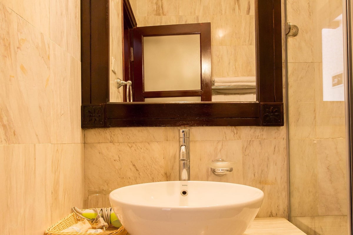 shower, hair dryer, slippers, towels