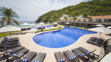 Relax by the inviting pool surrounded by lounge chairs and lush greenery.