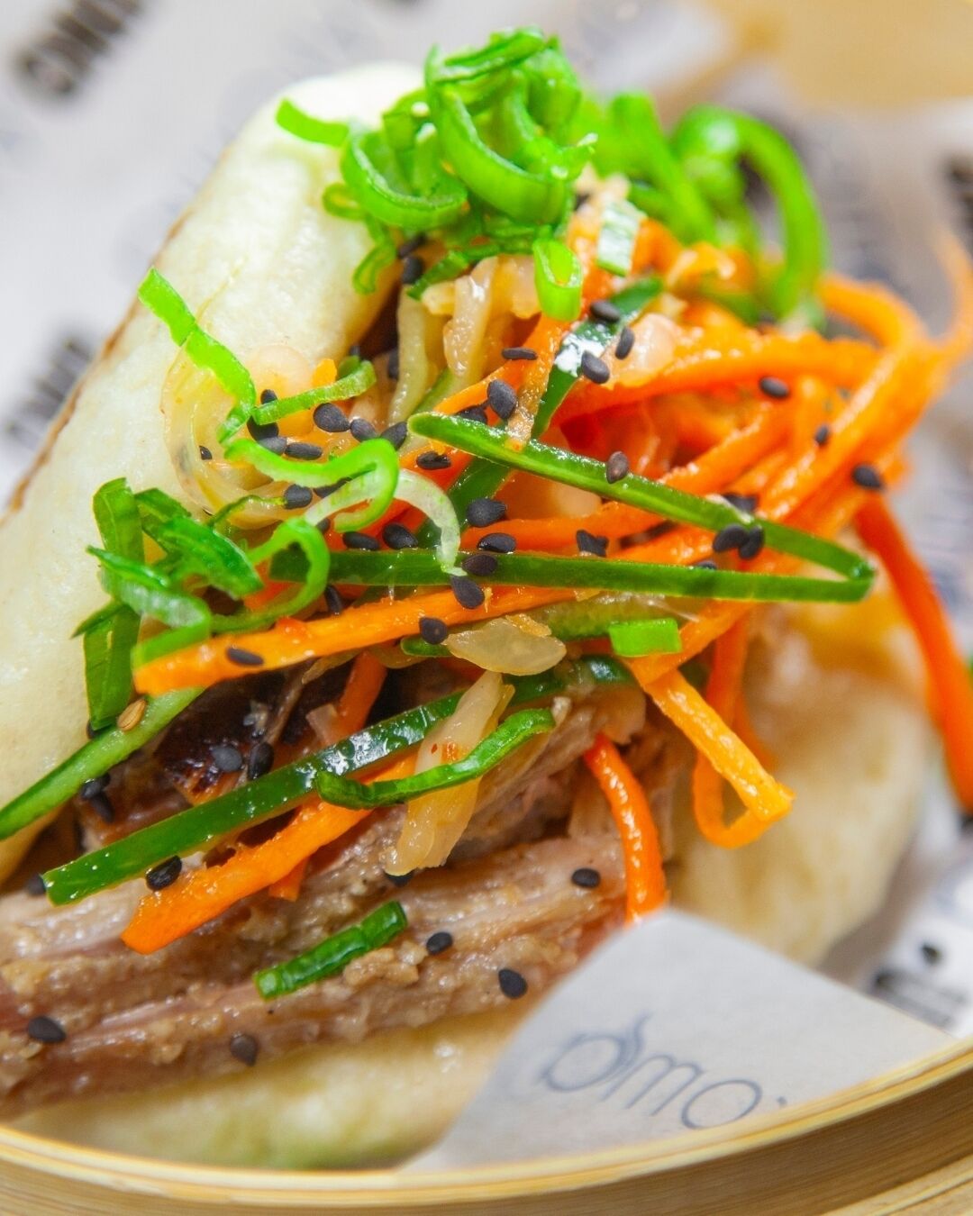A close-up of a sandwich with various toppings.