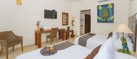A hotel room with two beds, a desk, a chair, a television, and artwork on the walls.