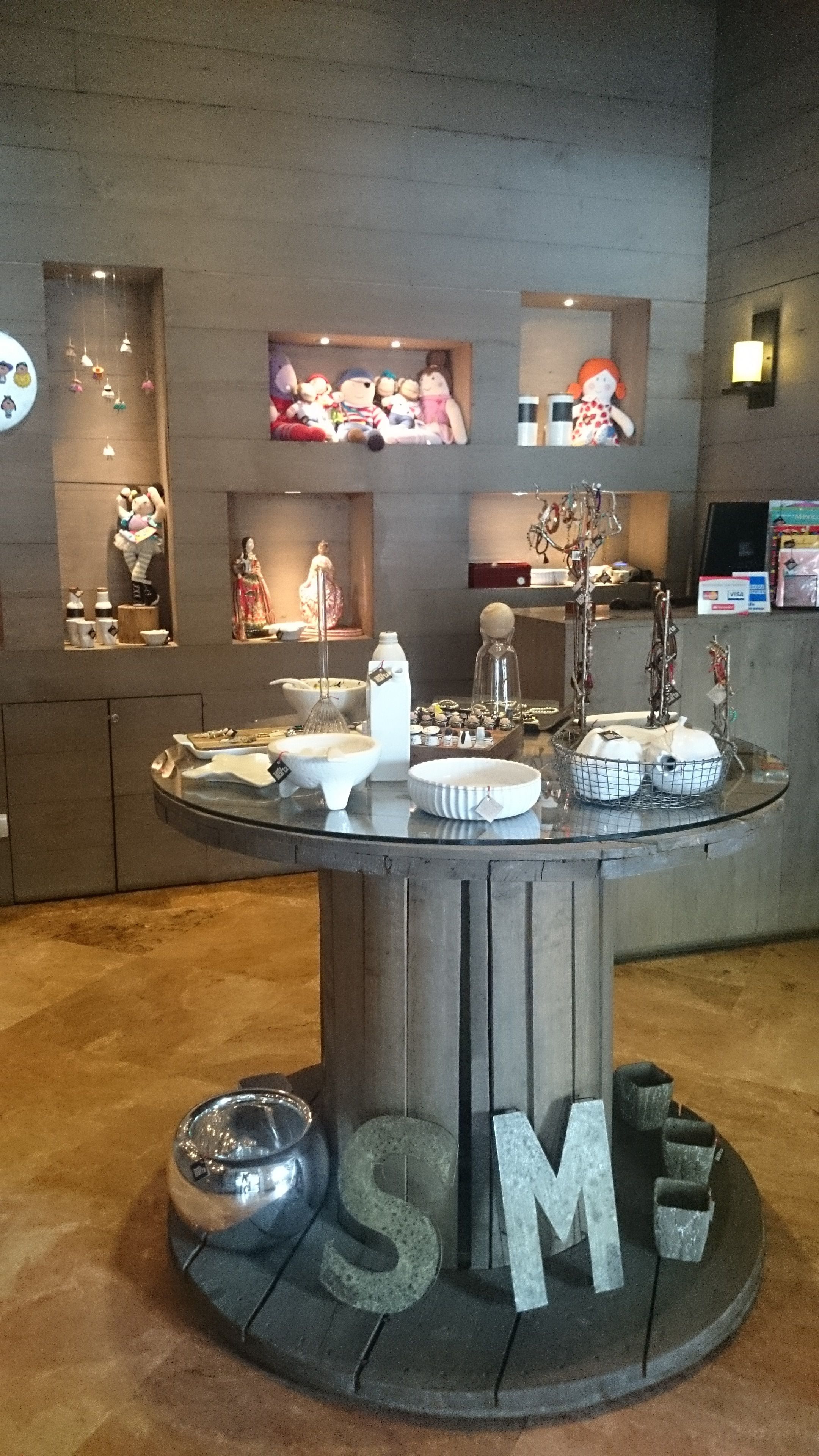 A dining area with a central round table displaying various dishes and utensils.