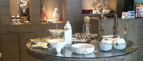 A dining area with a central round table displaying various dishes and utensils.