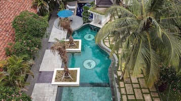 Una piscina al aire libre, sombrillas, sillones reclinables de piscina