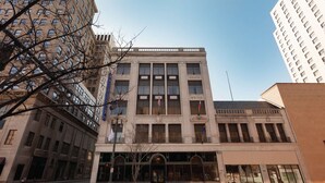 A multi-story building with a classical architectural style, featuring large windows and a central entrance.