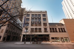 A multi-story building with a classical architectural style, featuring large windows and a central entrance.