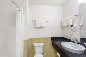 A bathroom with a toilet, sink, and shower. - Motel 6 Laredo, TX - Airport (Laredo)