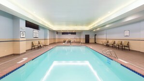 A large indoor swimming pool with multiple lanes, lounge chairs, and a no diving sign on the wall. - Staybridge Suites Seattle - Fremont by IHG (Seattle)