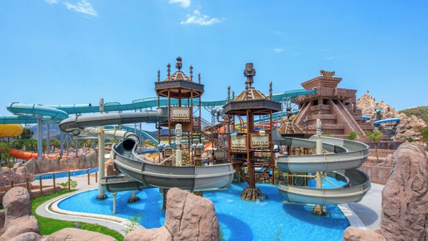 A water park with multiple water slides and a central pool. - Orka World Hotel & Aquapark (Fethiye)