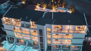 A modern multi-story building with a rooftop pool area and multiple balconies. - Orka World Hotel & Aquapark (Fethiye)