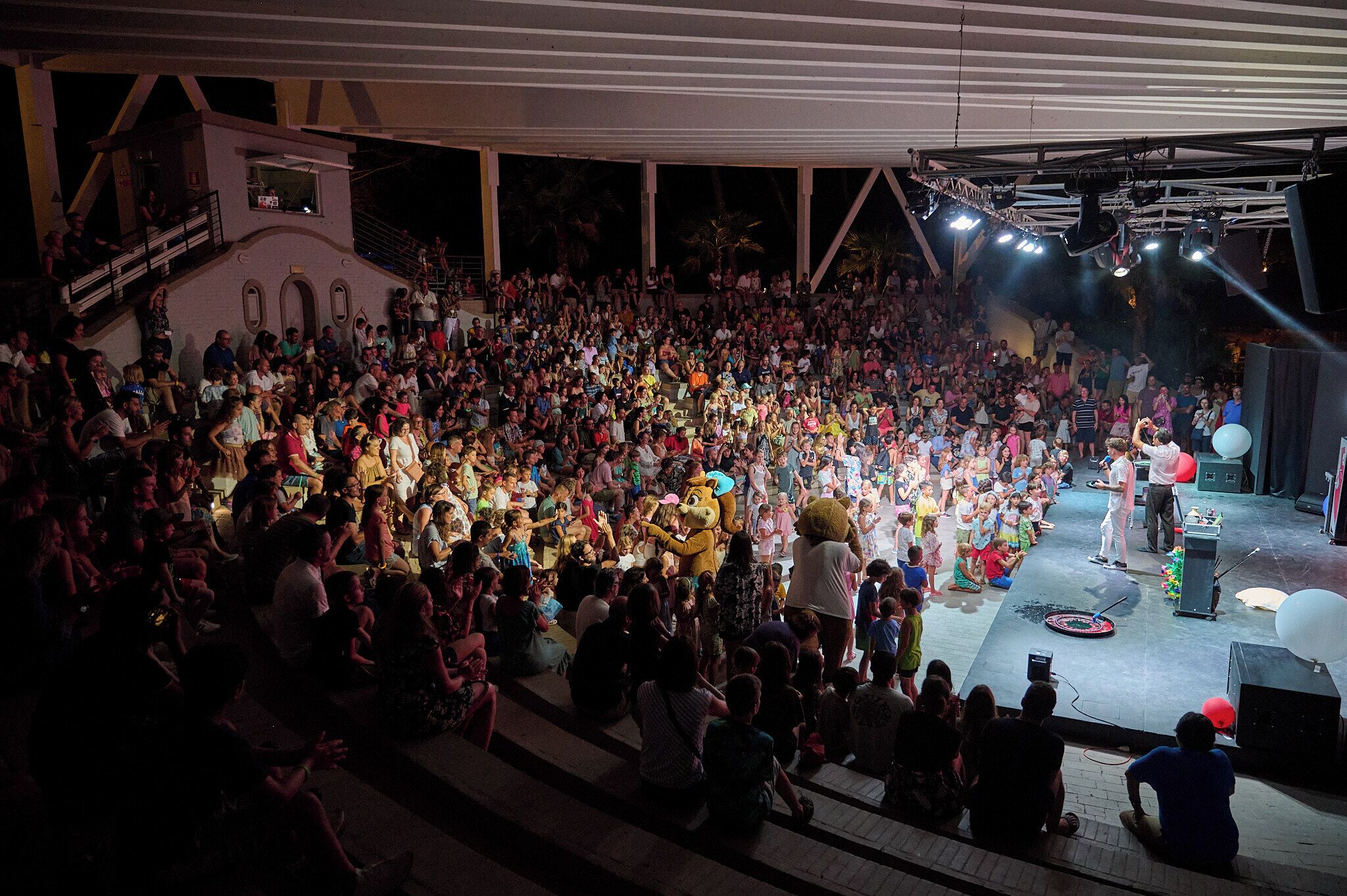 A large outdoor event with a stage and audience.